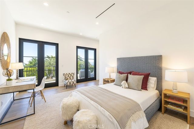 a bedroom with a bed and a large window