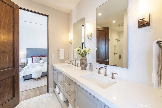 a en suite bathroom with a double vanity sink mirror and