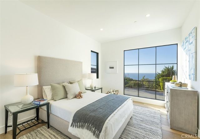a bedroom with a bed and a view of balcony