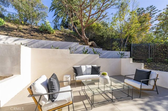 a view of a patio with couple of chairs