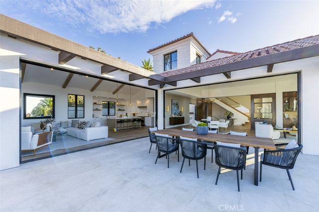 a view of a patio with dining table and chairs
