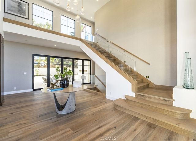 a view of entryway and hall with wooden floor