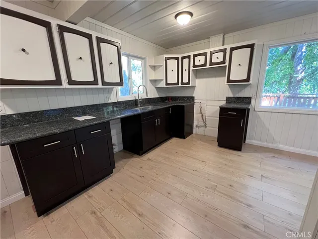 a kitchen with stainless steel appliances granite countertop a stove a sink dishwasher and a refrigerator