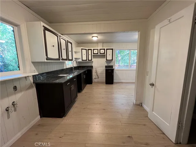 a kitchen with granite countertop a refrigerator and a stove