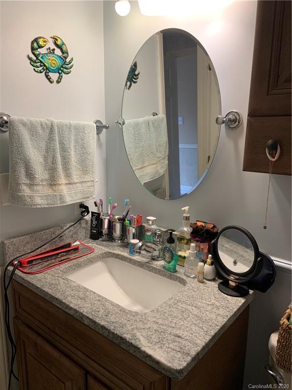 103 Sycamore Road, Unit 208 Salisbury, NC 28147 - Photo 12 of 20 a bathroom with a granite countertop sink and a mirror