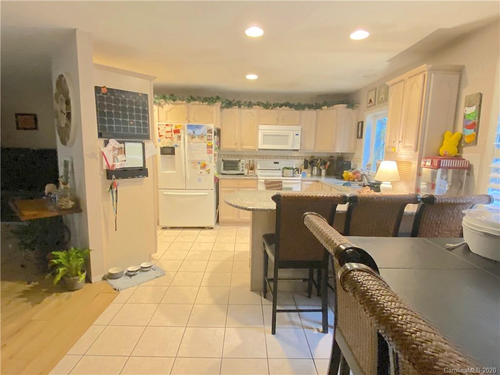 103 Sycamore Road, Unit 208 Salisbury, NC 28147 - Photo 7 of 20 a living room with stainless steel appliances furniture a rug and a kitchen view