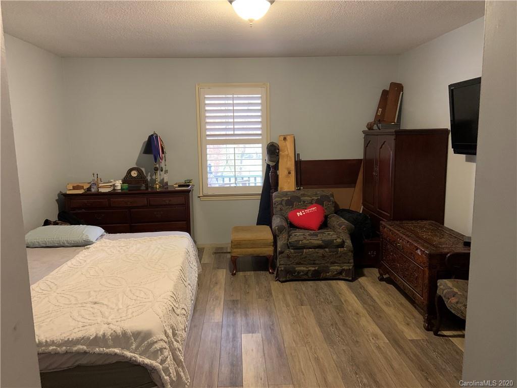103 Sycamore Road, Unit 208 Salisbury, NC 28147 - Photo 9 of 20 a bedroom with a bed and a flat tv screen on a dresser