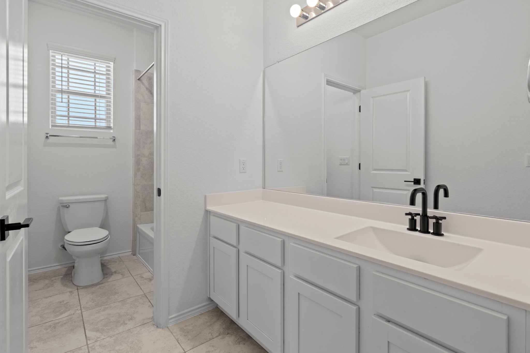 1101 Skeeter Cove Austin, TX 78748 - Photo 23 of 31 A well-appointed bathroom features a single vanity and a shower-tub combo, reflecting modern practicality.
