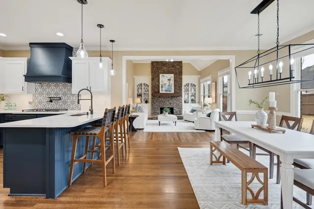 a large kitchen with a table and chairs