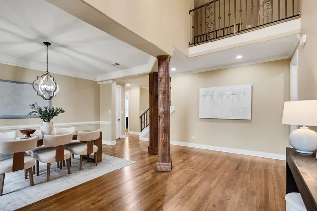 a view of a dining room with furniture wooden floor and chandelier