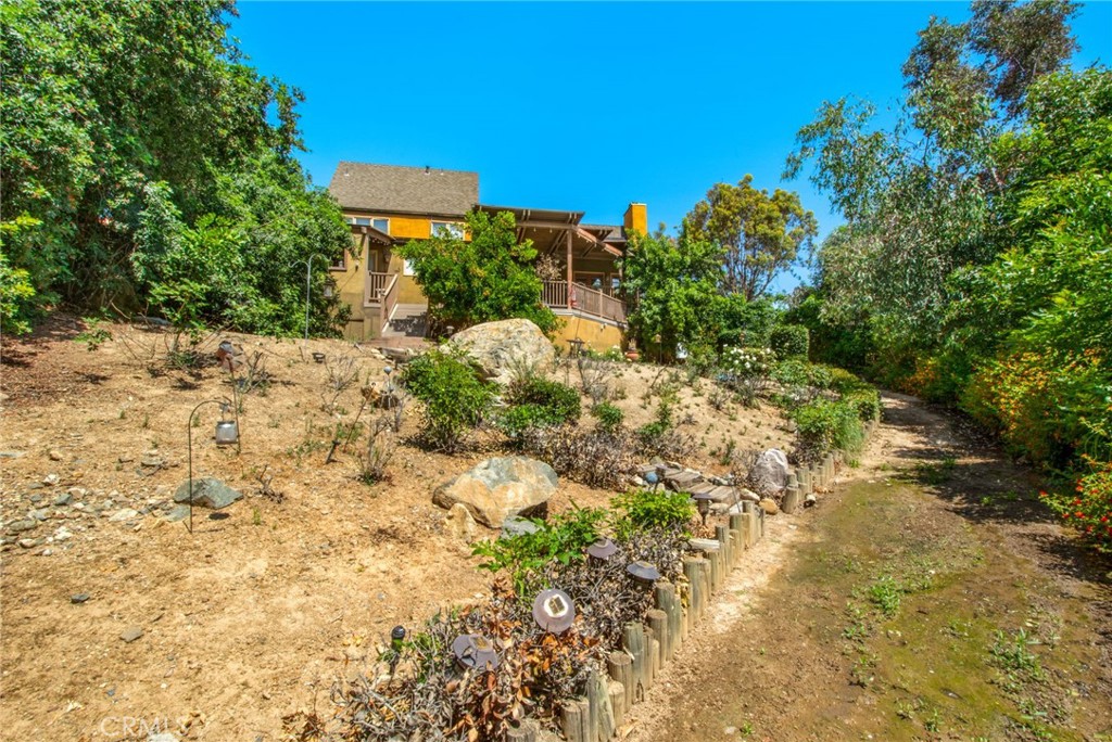 7241 Old Temescal Road Corona, CA 92881 - Photo 4 of 47 a view of a garden with plants and a bench