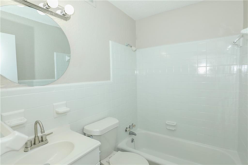 2065 Alison Court Southwest, Unit 8 Atlanta, GA 30311 - Photo 12 of 14 a bathroom with a bathtub shower sink vanity and a toilet