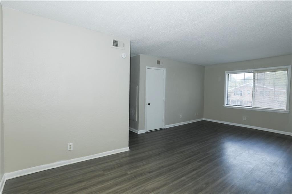 2065 Alison Court Southwest, Unit 8 Atlanta, GA 30311 - Photo 2 of 14 an empty room with wooden floor and windows