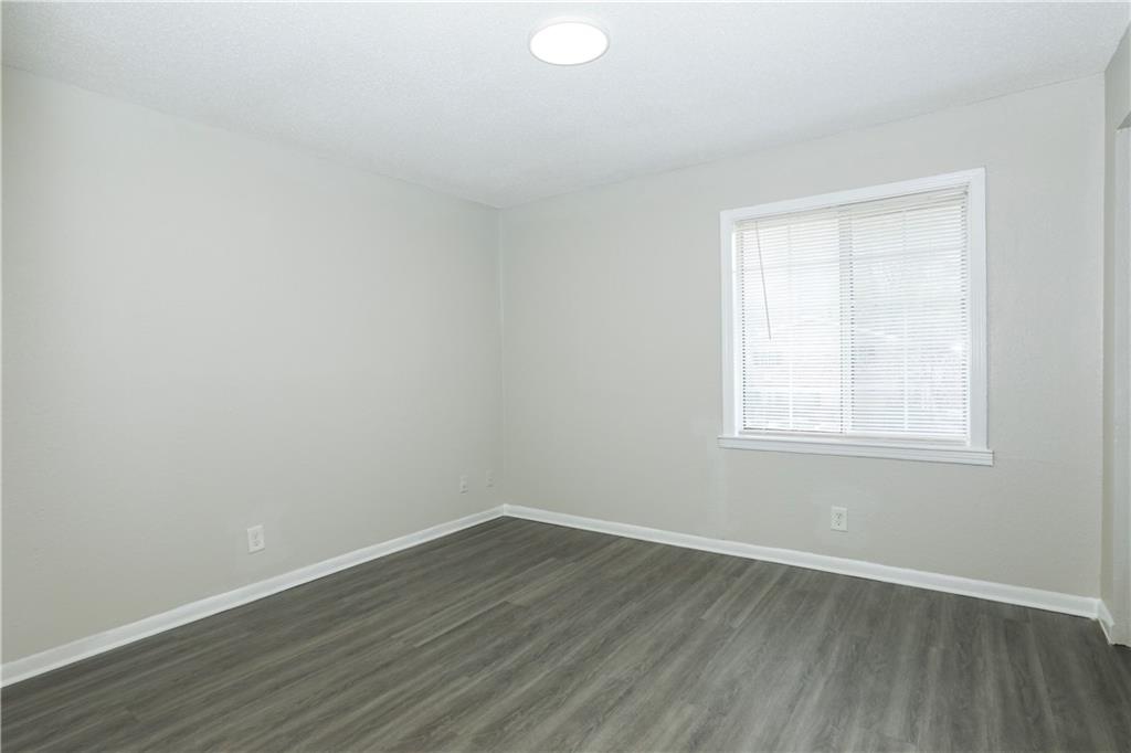 2065 Alison Court Southwest, Unit 8 Atlanta, GA 30311 - Photo 7 of 14 an empty room with wooden floor and windows