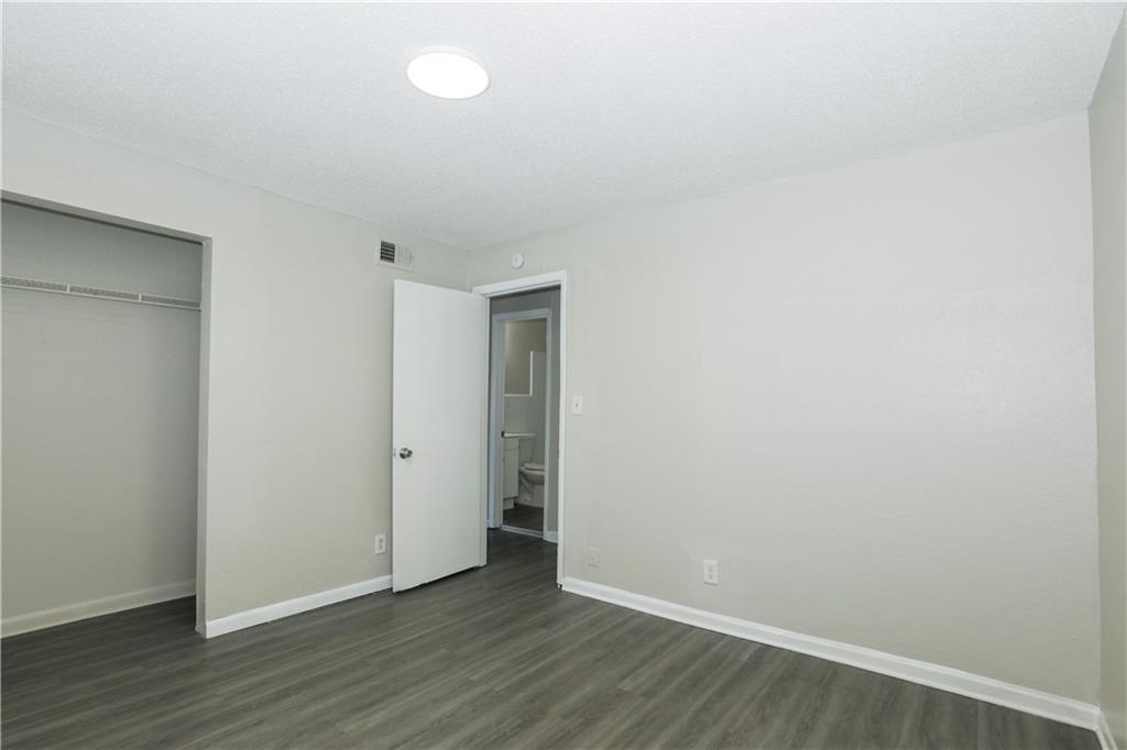 2065 Alison Court Southwest, Unit 8 Atlanta, GA 30311 - Photo 8 of 14 a view of an empty room with wooden floor