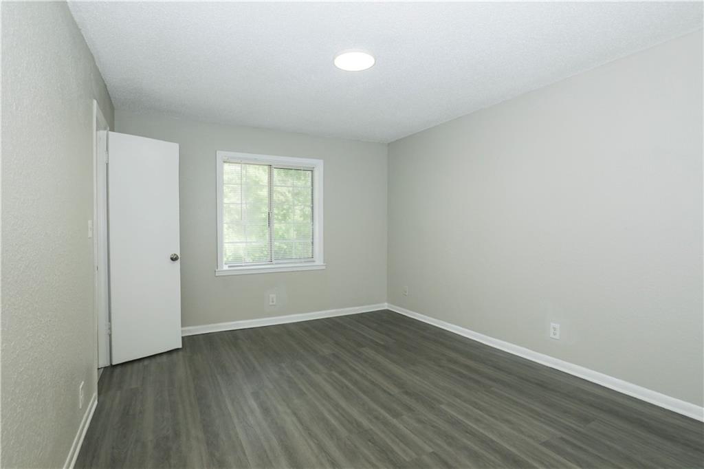 2065 Alison Court Southwest, Unit 8 Atlanta, GA 30311 - Photo 9 of 14 an empty room with wooden floor and windows