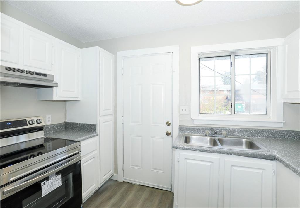 2065 Alison Court Southwest, Unit 8 Atlanta, GA 30311 - Photo 10 of 14 a kitchen with stainless steel appliances a sink stove and cabinets