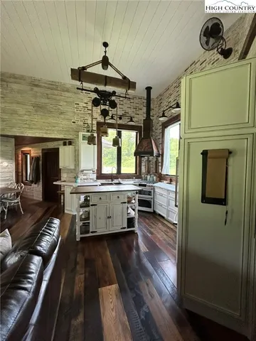 a dining room with furniture and wooden floor