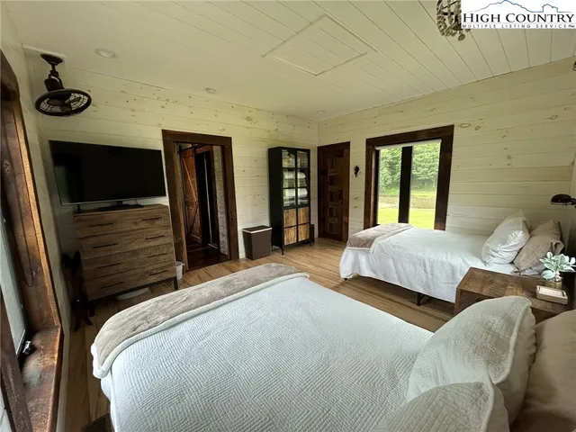 a bathroom with a granite countertop sink a mirror and a shower