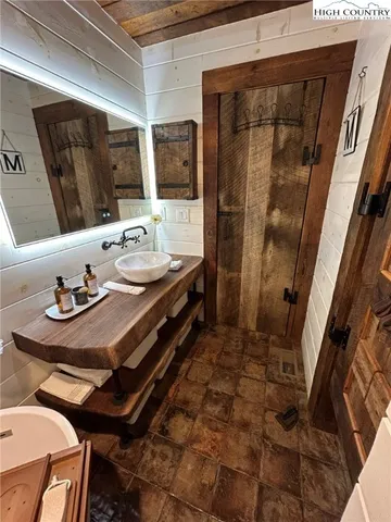 a bathroom with a sink a mirror and a toilet