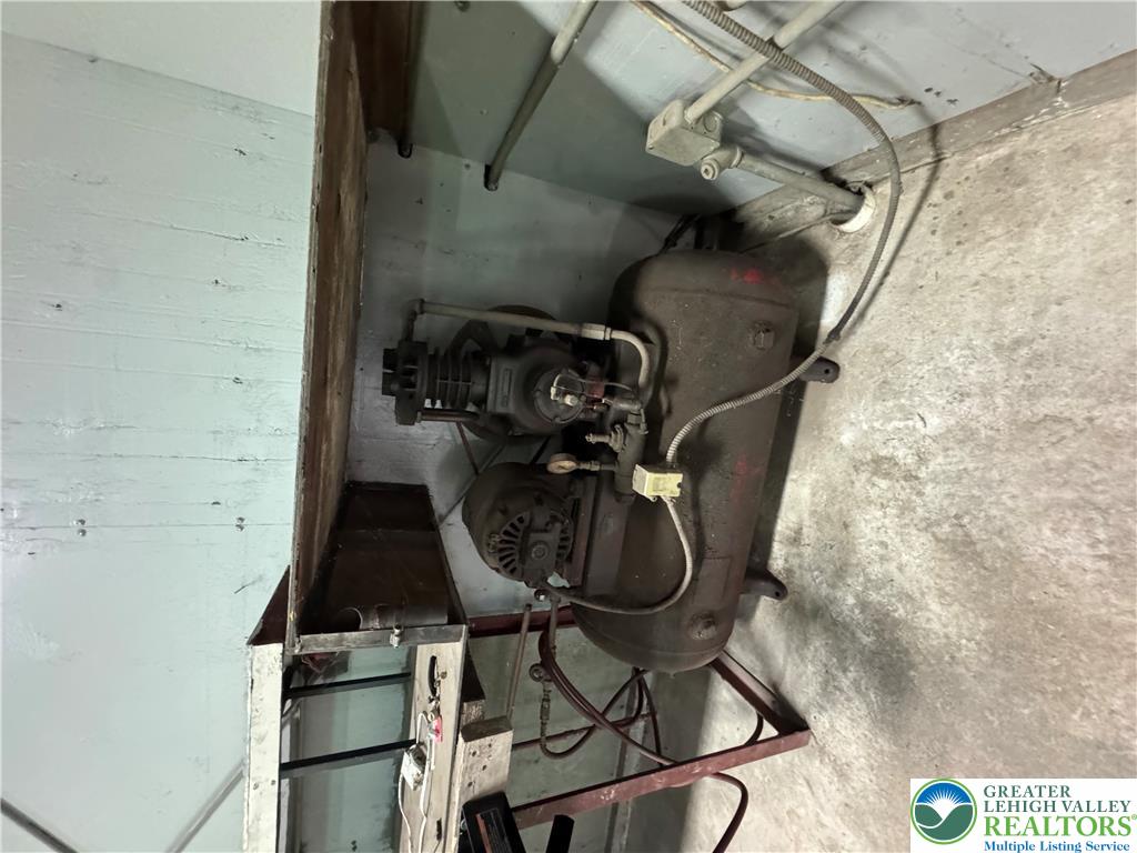 868 Catawissa Road Tamaqua, PA 18252 - Photo 63 of 67 Essential mechanical equipment, an air compressor, is thoughtfully organized within a functional utility space.