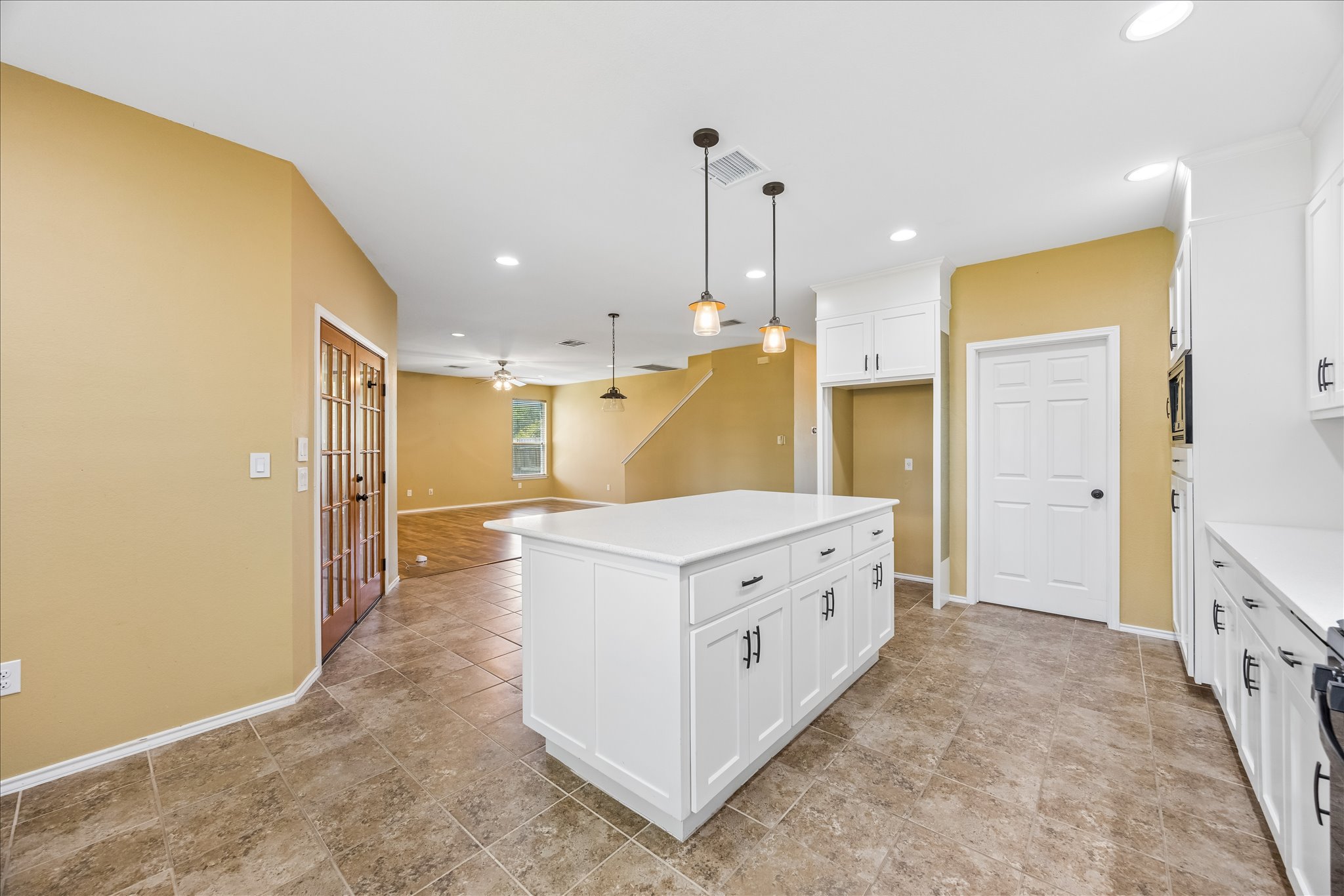338 Spring Branch Loop Kyle, TX 78640 - Photo 8 of 36 A central island anchors this inviting kitchen, seamlessly connecting to the adjacent living space.