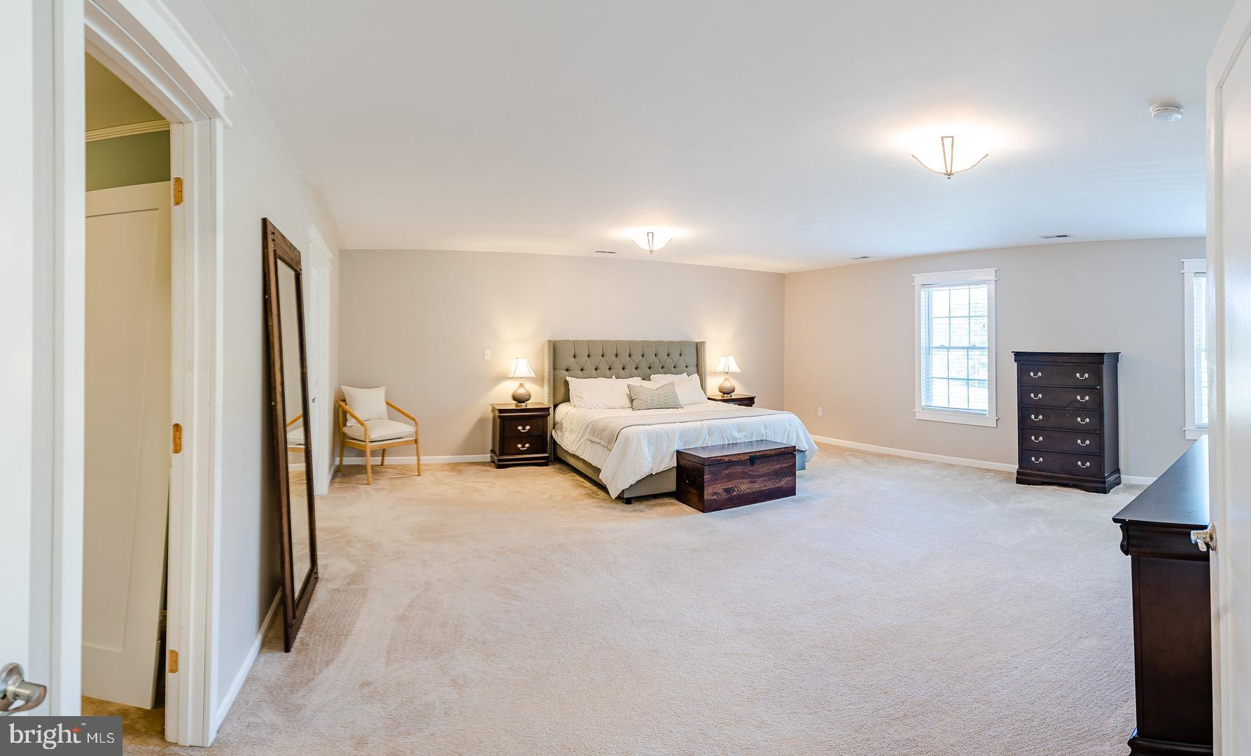 6825 Briscoe Turn Road Owings, MD 20736 - Photo 4 of 47 a spacious bedroom with a bed and a tv