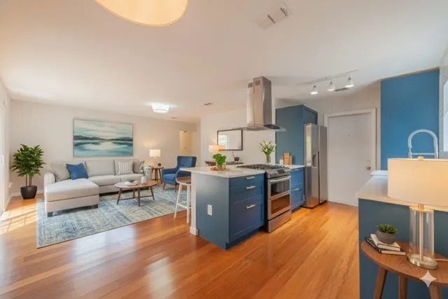 a backyard of a house with barbeque oven table and chairs