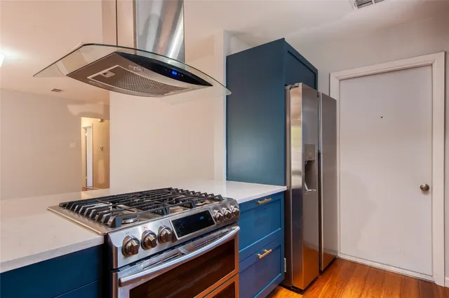 a kitchen with stainless steel appliances a stove top oven and cabinets