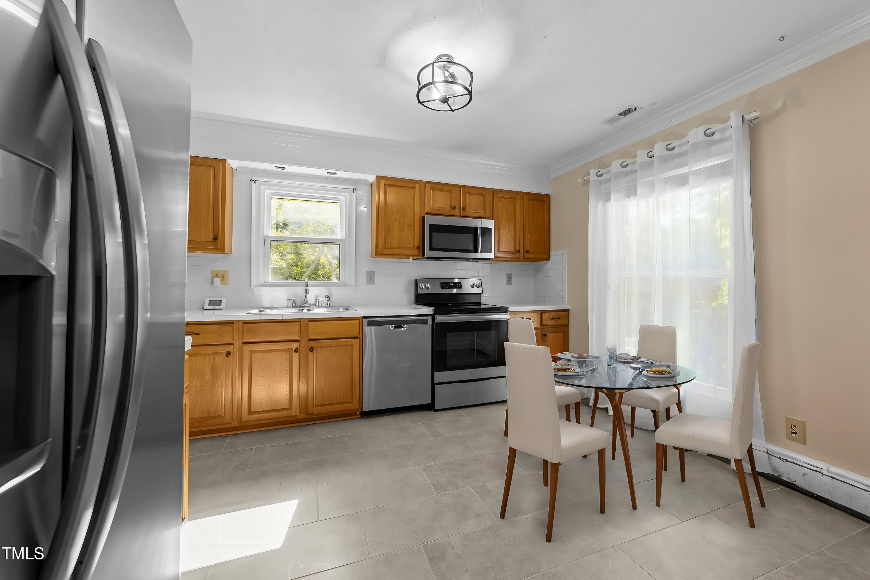 1104 Terrace Court Raleigh, NC 27615 - Photo 2 of 39 a kitchen with a sink cabinets and stainless steel appliances