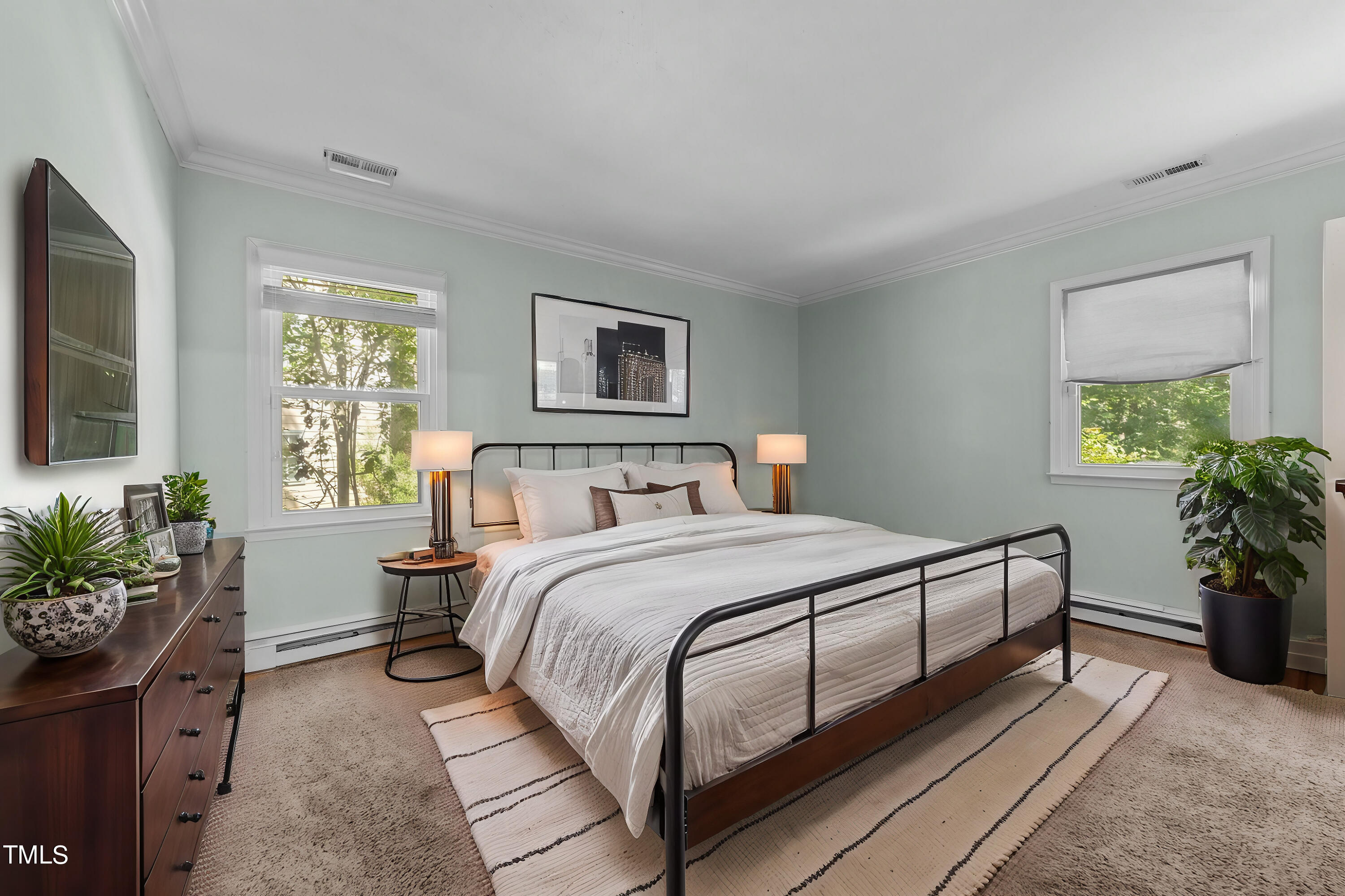 1104 Terrace Court Raleigh, NC 27615 - Photo 5 of 39 a bedroom with a bed and windows