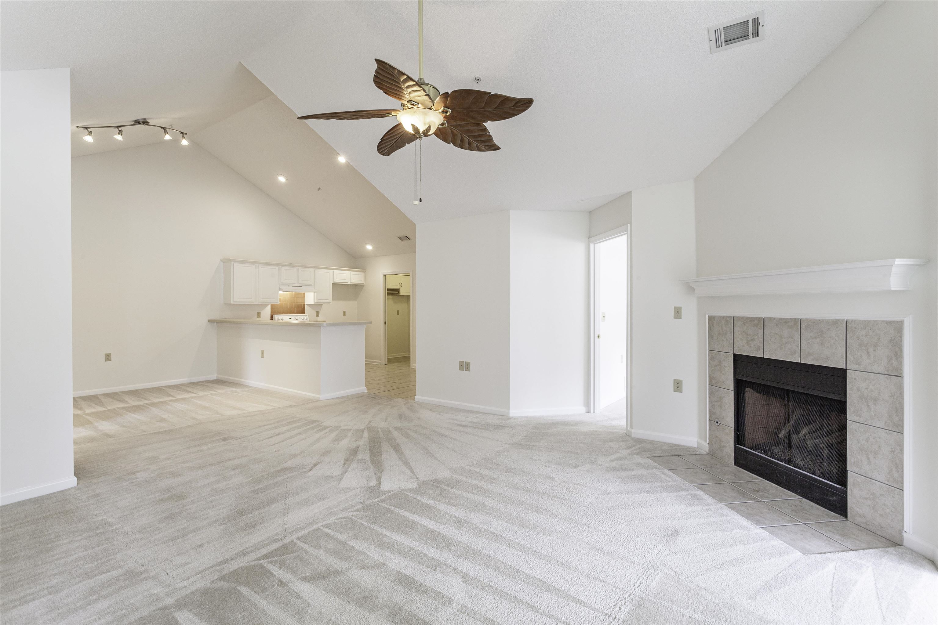 a view of an empty room with a fireplace