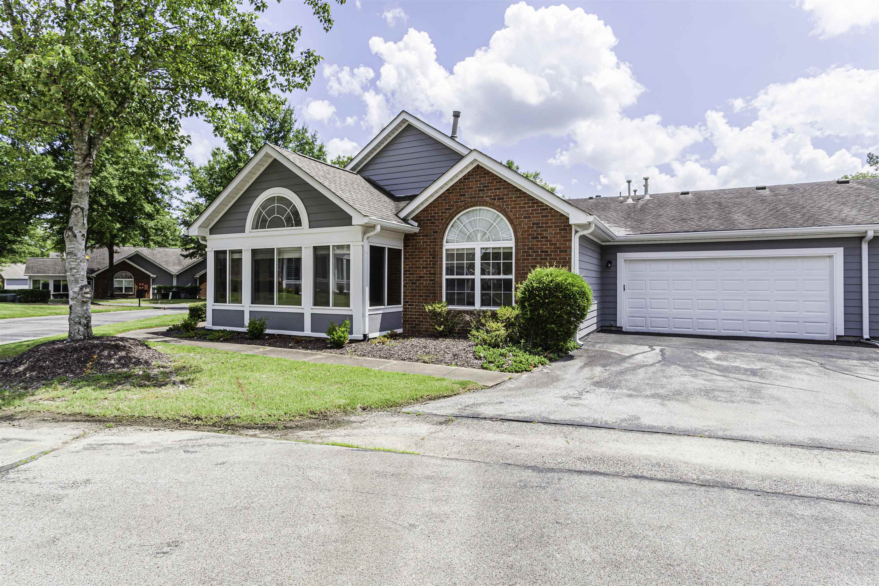 1187 Oak Timber Circle, Unit 33 Collierville, TN 38017 - Photo 13 of 22 a front view of a house with a yard and garage