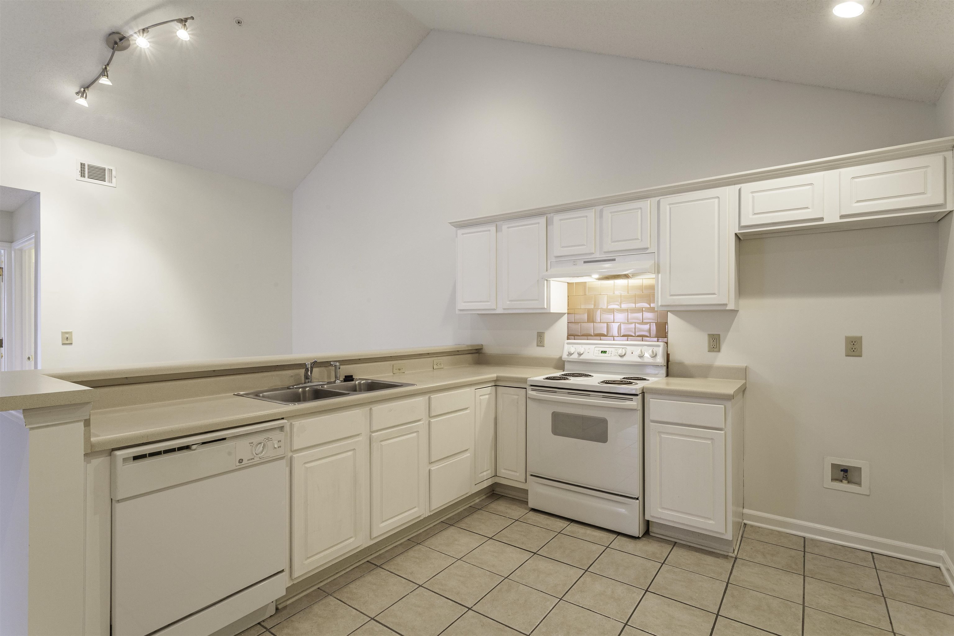 1187 Oak Timber Circle, Unit 33 Collierville, TN 38017 - Photo 15 of 22 a kitchen with a stove sink and cabinets