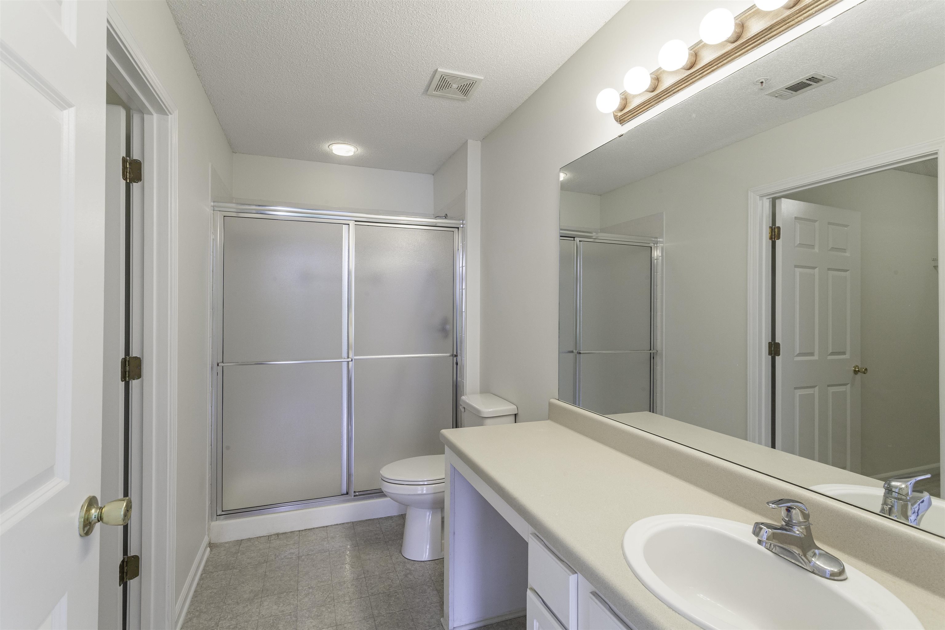 1187 Oak Timber Circle, Unit 33 Collierville, TN 38017 - Photo 5 of 22 a bathroom with a granite countertop sink toilet and shower