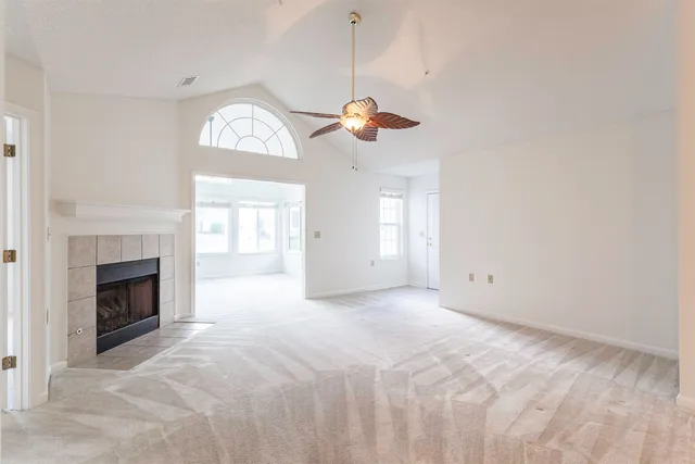 a view of empty room with a fireplace