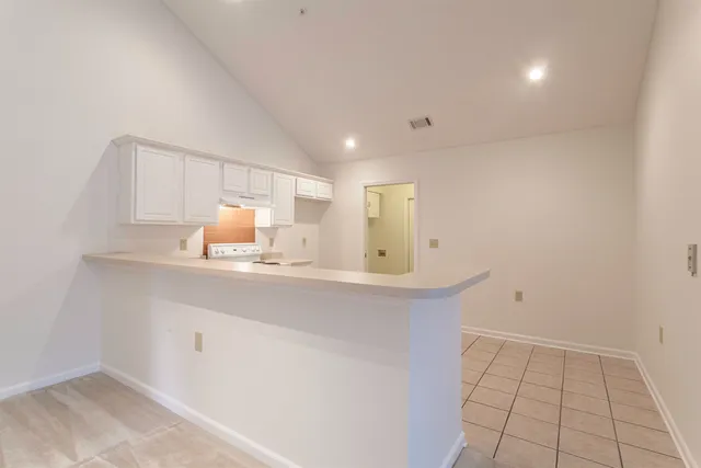 a kitchen with a sink cabinets and appliances