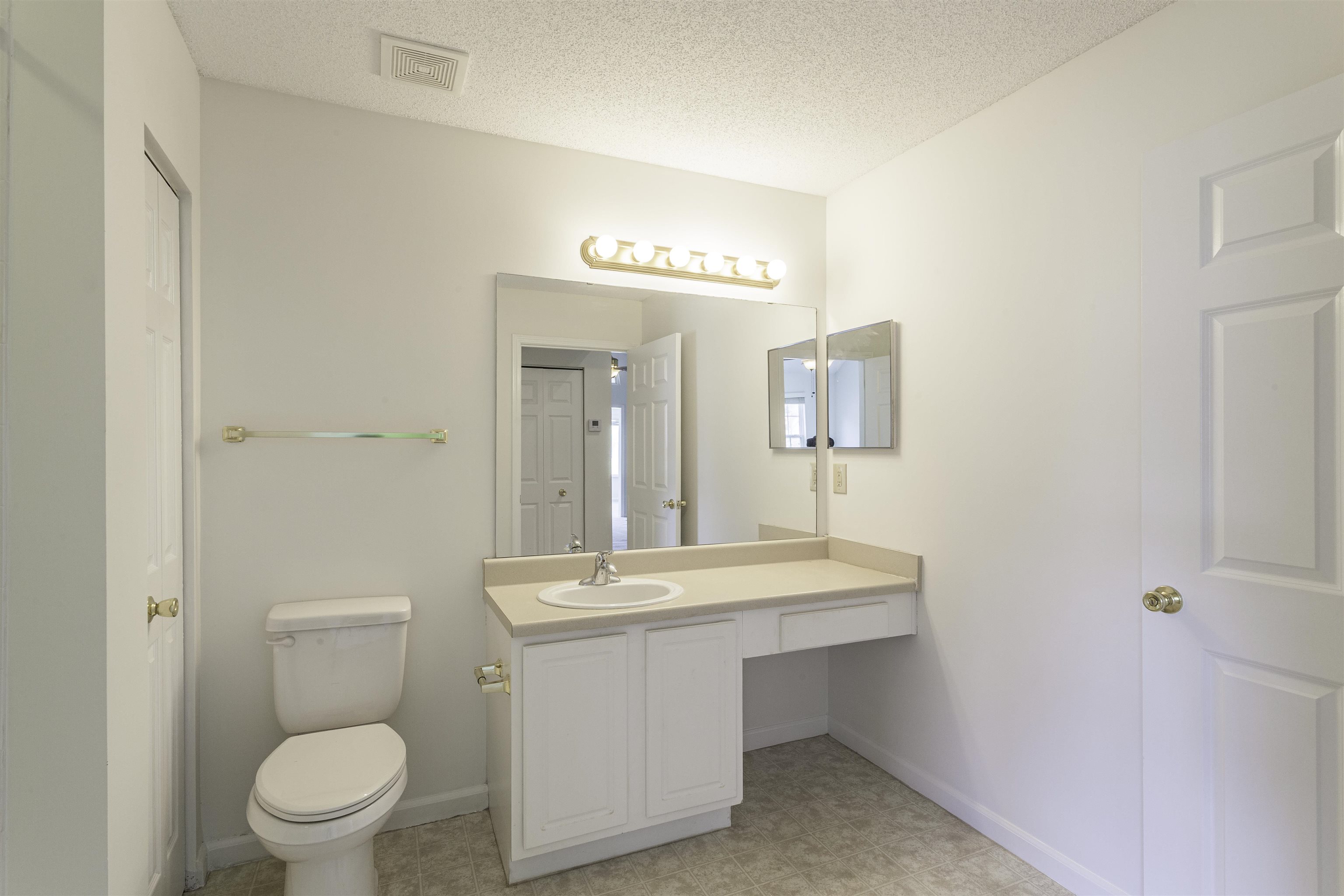 1187 Oak Timber Circle, Unit 33 Collierville, TN 38017 - Photo 9 of 22 a bathroom with a toilet a sink and mirror