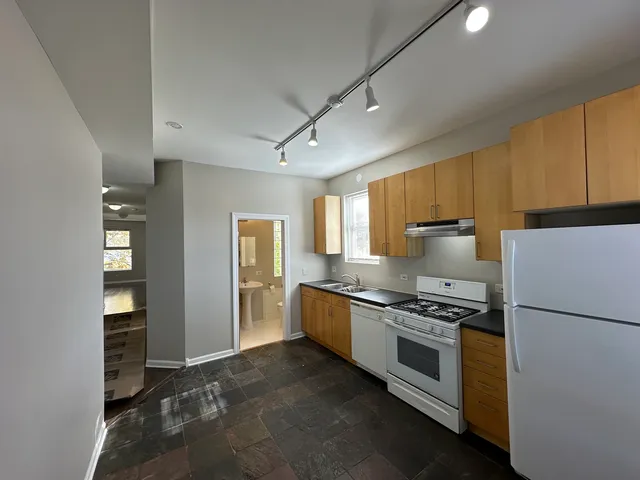 a kitchen with stainless steel appliances a refrigerator stove and microwave