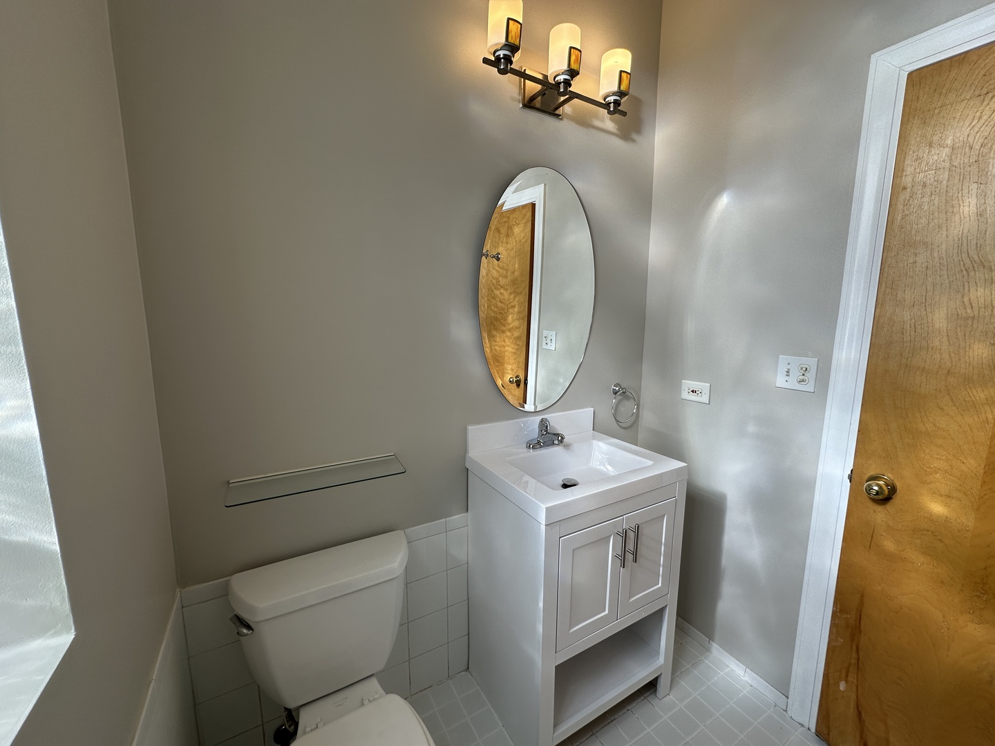 3946 North Cicero Avenue, Unit 1 Chicago, IL 60641 - Photo 4 of 17 a bathroom with a sink a mirror and a toilet