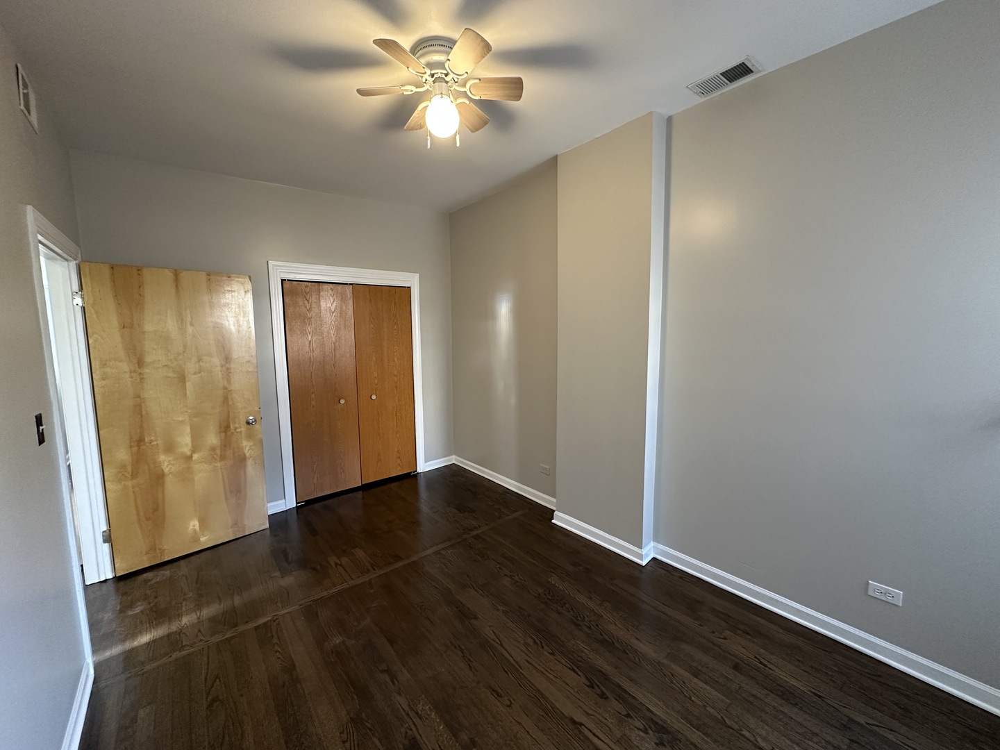 3946 North Cicero Avenue, Unit 1 Chicago, IL 60641 - Photo 8 of 17 a view of an empty room with wooden floor and a window