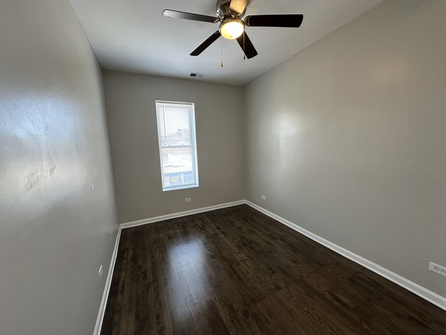 3946 North Cicero Avenue, Unit 1 Chicago, IL 60641 - Photo 10 of 17 an empty room with wooden floor chandelier fan and windows