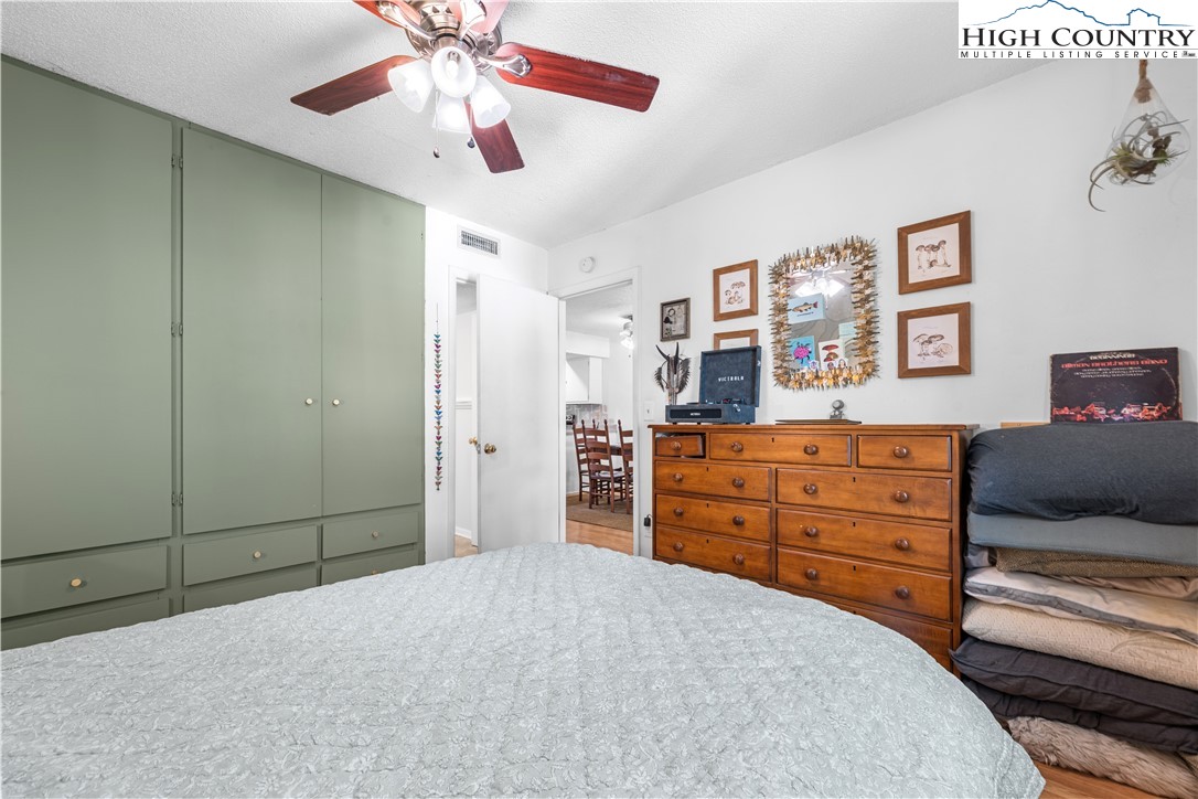 229 East King Street, Unit 17 Boone, NC 28607 - Photo 14 of 22 a bedroom with a bed and a chandelier