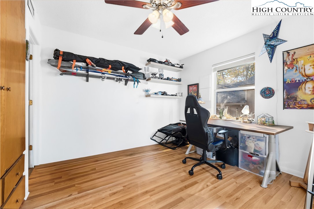 229 East King Street, Unit 17 Boone, NC 28607 - Photo 16 of 22 a view of workspace with wooden floor and ceiling fan