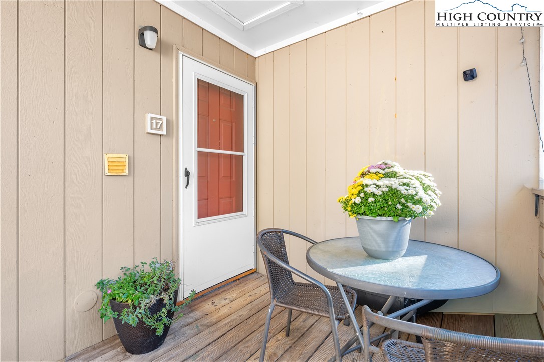 229 East King Street, Unit 17 Boone, NC 28607 - Photo 3 of 22 a view of a dining room with furniture and a potted plant