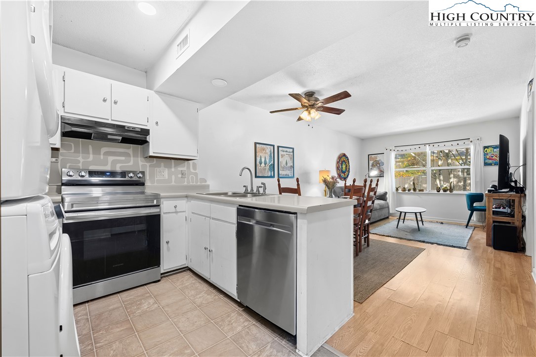 229 East King Street, Unit 17 Boone, NC 28607 - Photo 4 of 22 a kitchen with cabinets and stainless steel appliances