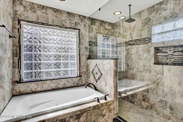 a bath tub sitting next to a shower