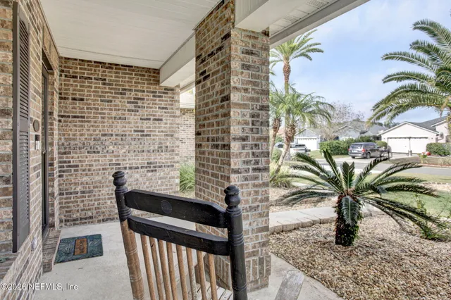 a vase of flowers sitting on a floor in front of a door