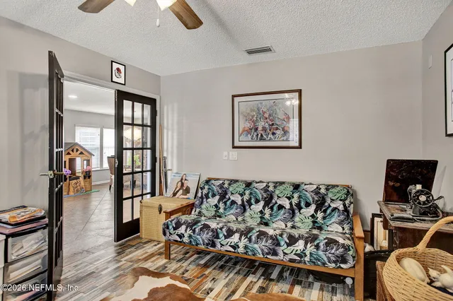 a view of a livingroom with furniture and a flat screen tv