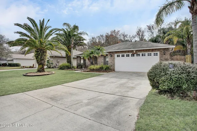 a front view of house with yard and green space